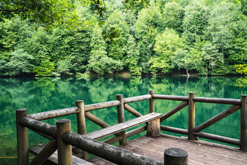 wooden dock with sitting bench on a lake in Yedigoller National Park Turkey