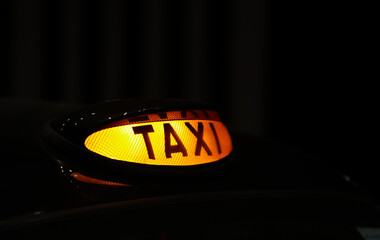 Taxi sign on top of a black cab in London, United Kingdom. Landmark image for England public transportation system. 