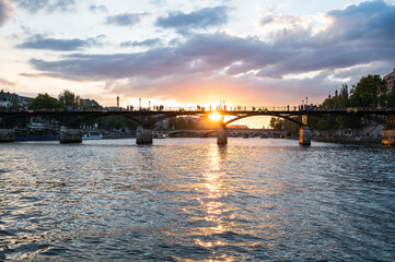 Fototapeta na wymiar Sunset at Pont des Arts, Paris, France or Passerelle des Arts is a pedestrian bridge that has an international reputation as the bridge of romance.