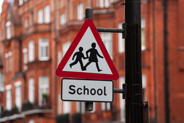 Be aware of pupils. Traffic indicator sign for school warning the drivers to slow down. Transportation industry.