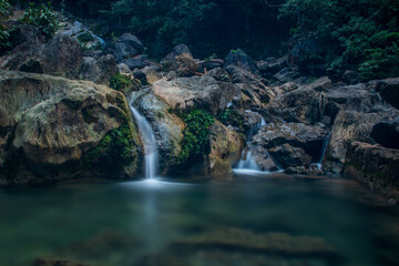 Photo of water flowing between rocks, waterfall in Pudeng village, Aceh, Indonesia.
