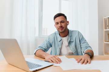 Fototapeta premium Cheerful friendly handsome stylish young businessman welcomes candidate for new vacation smile at camera in office. Copy space for ad. Remote Job, Technology And Career Profession Concept