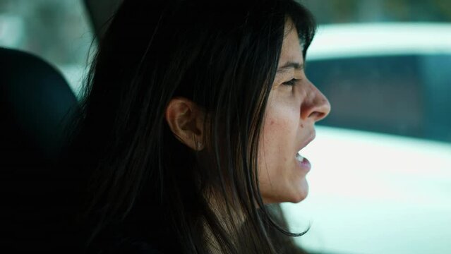 Sleepy driver yawning closeup face. Exhausted woman driving on road yawns