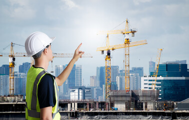 Asian civil engineer or architecture,professional worker man wearing white hat,young adult man working at construction site ,Concept work in success.