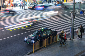 夜の東京　タクシーと車の光跡　Parked taxi cab and traffic light trails on street at night in Tokyo, Japan