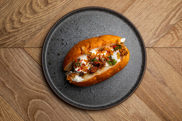 hot dog with grilled sausage, fried onion and pickled vegetables