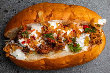 hot dog with grilled sausage, fried onion and pickled vegetables