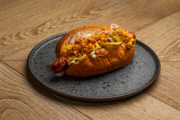 hot dog with grilled sausage, fried onion and pickled vegetables