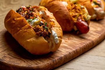 3 hot dogs with assorted grilled sausages, fried onions and pickled vegetables