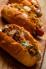 3 hot dogs with assorted grilled sausages, fried onions and pickled vegetables