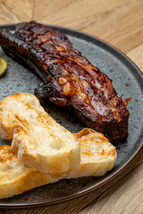 meat cooked in a smokehouse with bread and pickled cucumbers
