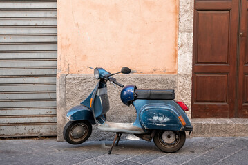 Taormina, Sicily, Italy. August 26, 2022. Scooter parked on street against old building. Vehicle on urban street at ancient coastal city. Old town during summer.