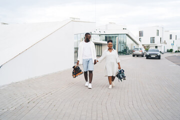 Black couple with inline skates on sidewalk