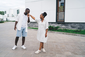 Romantic man kissing hand of girlfriend on street