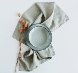 Fototapeta Plate mockup,linen napkin, dry grass  top view empty modern minimal table place setting neutral green colors .  Space for text or menu .Business food brand template. Scandinavian style tableware. obraz