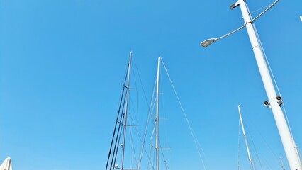 Fototapeta premium Genova, Italy- July 27, 2022:Panorama of the blue sea, light above the water, ocean sunrise. Some little waves in winter days. Clear sky reflected on the water.