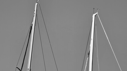 Fototapeta premium Genova, Italy- July 27, 2022:Panorama of the blue sea, light above the water, ocean sunrise. Some little waves in winter days. Clear sky reflected on the water.