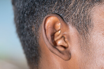 Human Ear - Close up of a man's ear Its body part helps to hear sound waves. 
