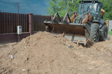 Excavator bucket close-up on the background of a construction site. Heavy earthmoving equipment. Soil development