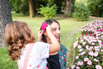 daughter putting a flower on her mother's head