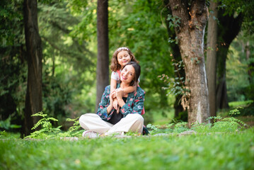 mother and daughter hugging each other happily and smiling