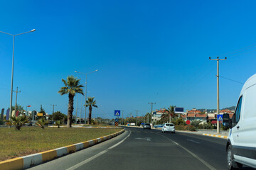 Fototapeta na wymiar Highway wide road, transport and blue sky with clouds on a summer day