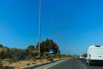 Fototapeta premium Highway wide road, transport and blue sky with clouds on a summer day