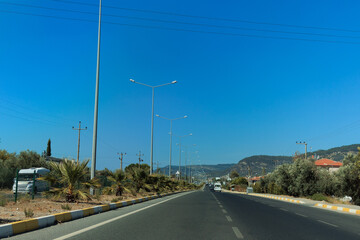Fototapeta premium Highway wide road, transport and blue sky with clouds on a summer day