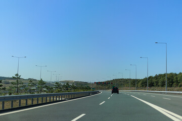 Fototapeta premium Highway wide road, transport and blue sky with clouds on a summer day
