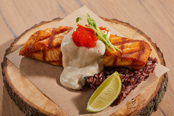 fish steak with cream on wooden background