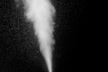 Curly white steam rising up and splashing water scattering in different directions isolated on a black background to overlay. Evaporation of liquid and condensation. Can be used as design element