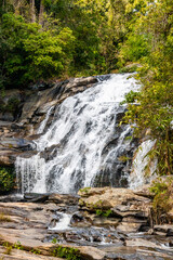Waterfall with beautiful rocks and splashing water in Thailand