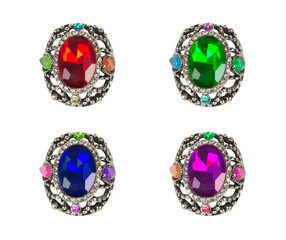 Luxurious rings with precious gems, four colors, isolated.