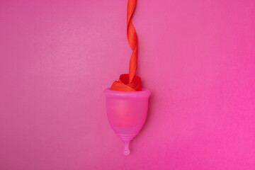 menstrual cup with red ribbon as female bleeding during menstruation, Menses, feminine hygiene...