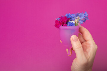 menstrual cup with flowers inside, feminine hygiene product