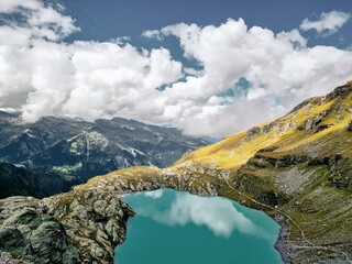 Naklejka na ściany i meble High altitude alpine lake surrounded by mountains