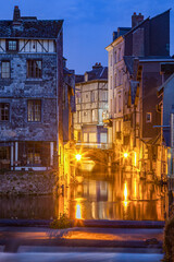 Naklejka premium Canal at night, city lights reflecting in the water, Pont-Audemer, River Risle, Normandy, France