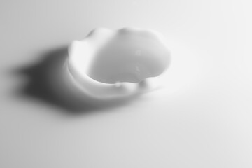 Closeup of drop of milk falling into milk bath