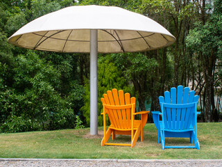 Colourful Orange And Blue Chairs Under an Umbrella
