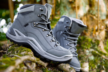 Elegant brand new hiking boots in sunny natural environment