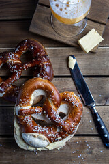 German Pretzel called Brezel,pastry from Southern with butter and glass of beer Germany,very popular in Oktoberfest.