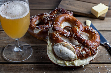 German Pretzel called Brezel,pastry from Southern with butter and glass of beer Germany,very popular in Oktoberfest.