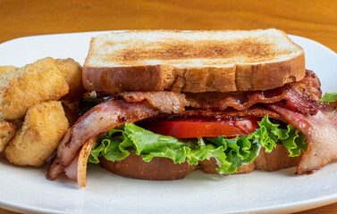 bacon lettuce tomato sandwich  with veggie tots