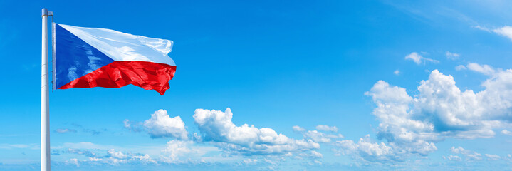 Czech flag waving on a blue sky in beautiful clouds - Horizontal banner