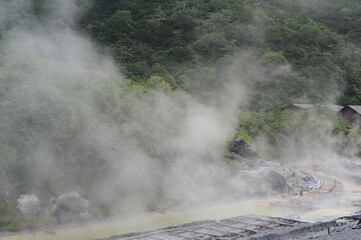 Sulphurous mountain valley with hot spring stream and steam at Tamagawa Onsen Hot spring in Senboku city, Akita prefecture, Tohoku region, northern Japan, Asia