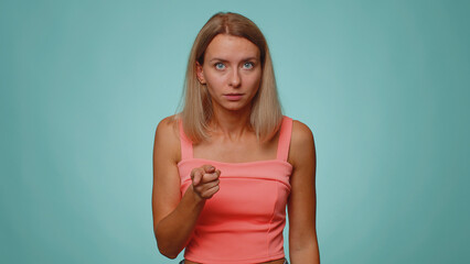 Quarrel. Displeased woman gesturing hands with irritation and displeasure, blaming scolding for failure, asking why this happened. Young slim thin girl isolated alone on blue studio wall background