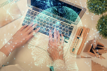 Double exposure of woman working on computer andhuman brain hologram drawing. Top View. Ai concept.