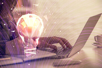 Double exposure of woman hands typing on computer and light bulb drawing. Idea concept.