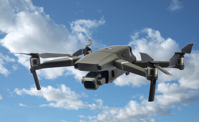 A flying drone isolated on cloudy sky background