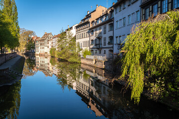 Fototapeta na wymiar Traditional old alsatian houses from Pont st. Martin on a canal in Petit Venice (Small Venice) in Stasbourg in Alsace in the department of Haut-Rhin of the Grand Est region of France